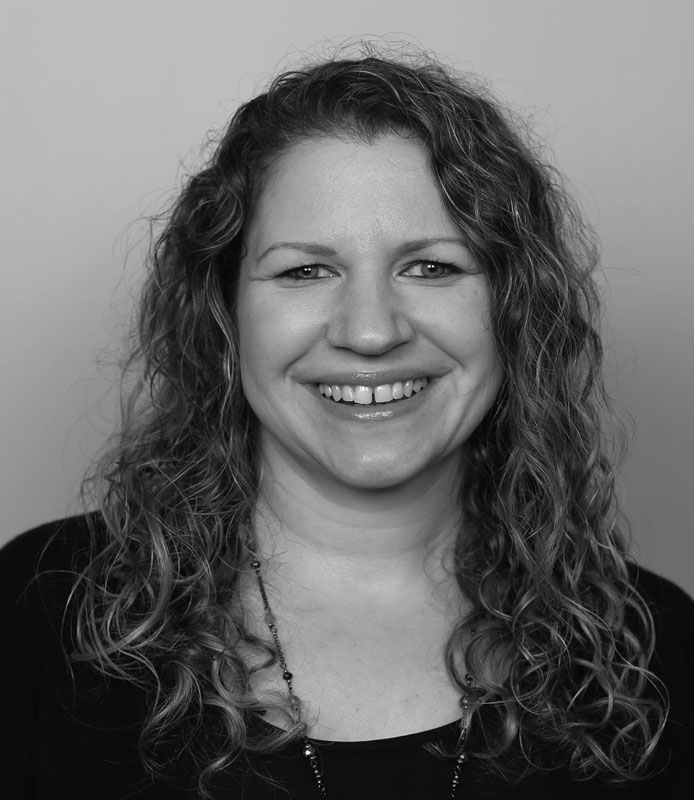 Denise Becker, middle-aged adult woman with light curly hair, wearing black shirt, black and white headshot, Hillsborough Education Foundation