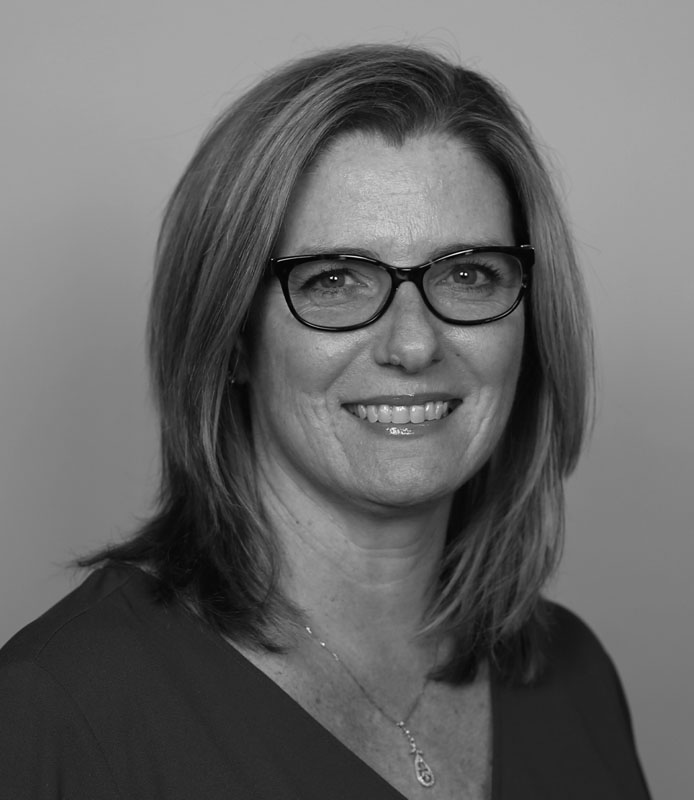 Mindy Taylor, young adult woman, wearing glasses, smiling, black-and-white, Hillsborough Education Foundation
